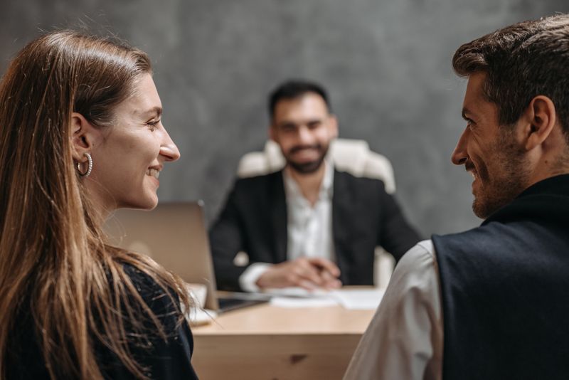 Two clients meeting with a personal injury lawyer in an office