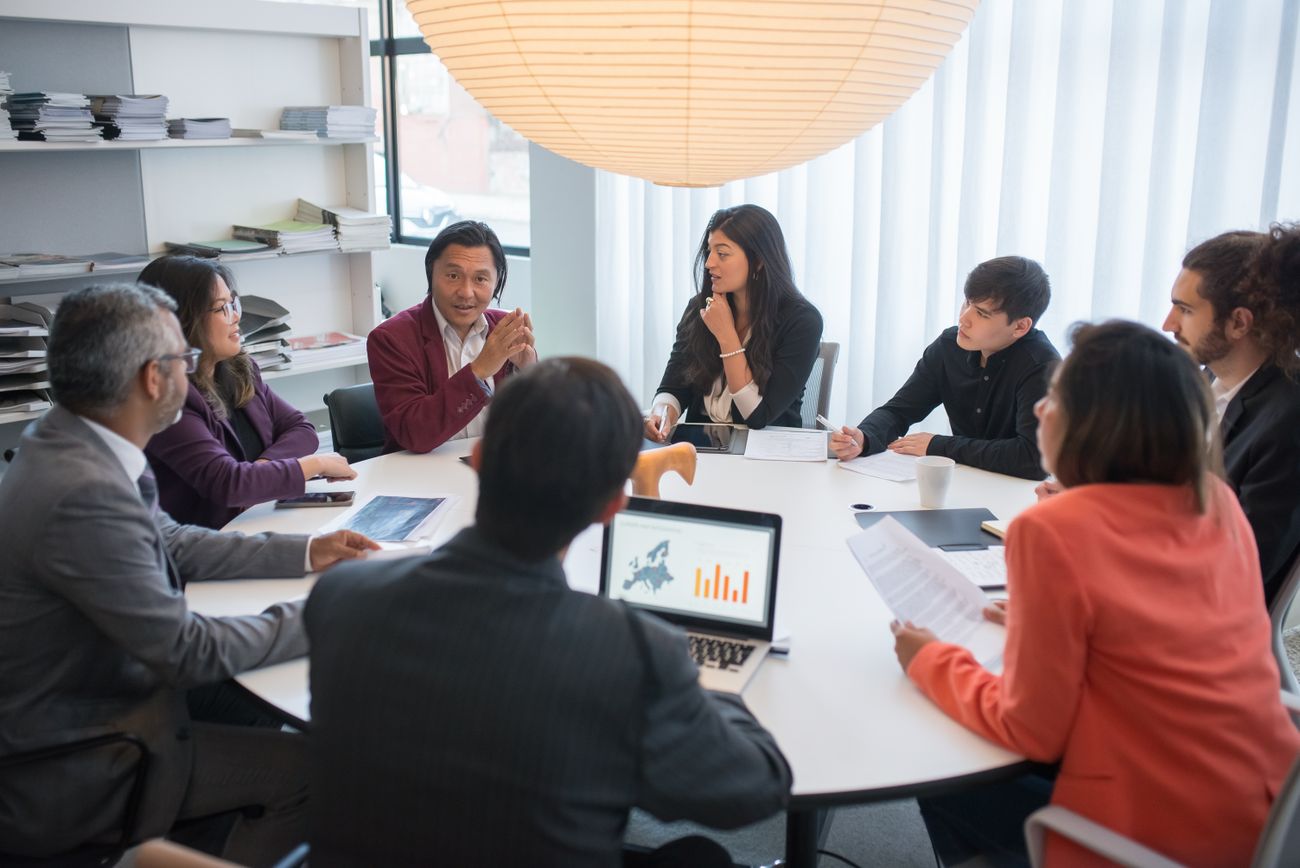 A team of professional advisors in a conference-room strategy discussion